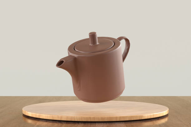 istock A brown tea pot is floating in the air above a wooden table 2187479726