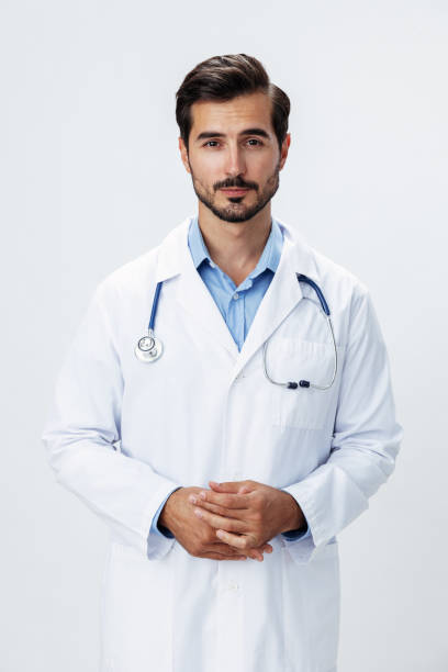 istock Man doctor in a white coat with a stethoscope smile with teeth and good test results looking into the camera on a white isolated background, copy space, space for text, health 2187481126