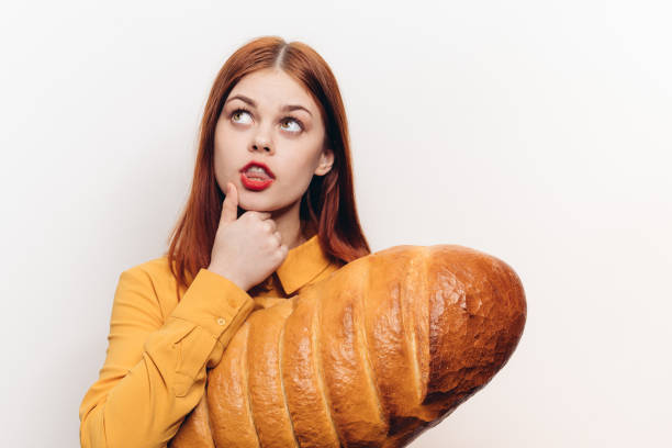 istock interested woman with a large loaf surprised look light background 2187481367