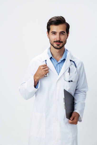 istock Man doctor in white coat with stethoscope and folder for notes and patient records smile and good test results look into camera on white isolated background, copy space, space for text, health 2187481465