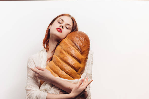istock beautiful woman hugging loaf with her hands makeup transparent fabric on her shoulders 2187482349
