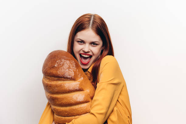 istock a cheerful woman with bright makeup hugs a loaf with her hands 2187482364