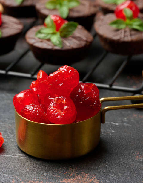 istock Candied red cherries in a copper bowl on a table 2187482656