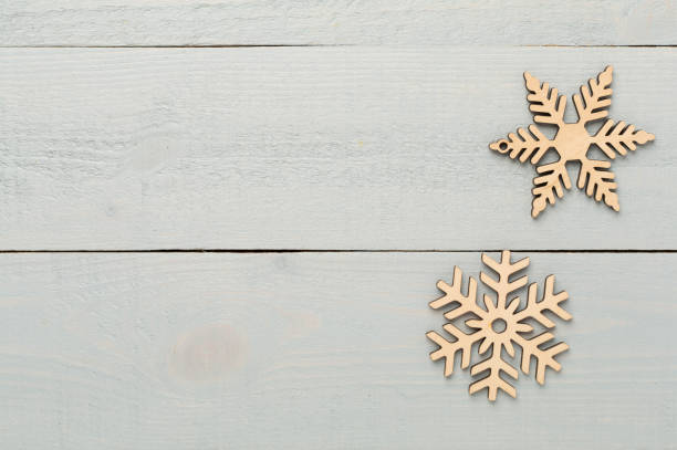 istock Beautiful snowflake on woden background, top view 2187482699