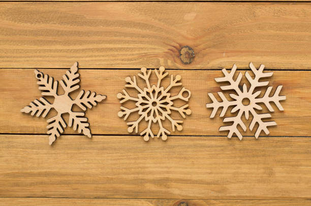istock Beautiful snowflake on woden background, top view 2187482701