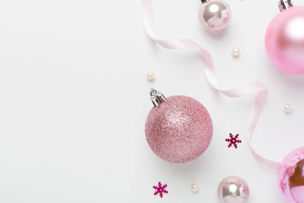 istock Pink christmas balls with decor on color background, top view 2187482710