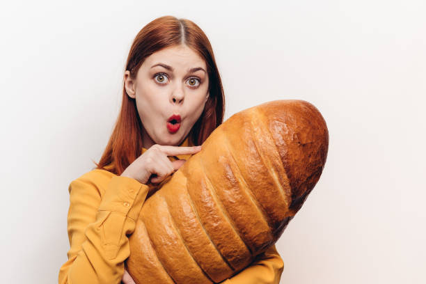 istock interested woman with a large loaf surprised look light background 2187482790