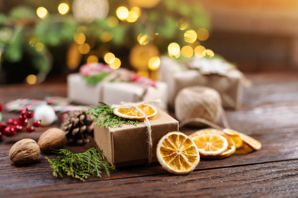 istock Christmas and zero waste, eco friendly packaging gift on wooden background under christmas tree. Eco christmas holiday concept. Sustainable christmas 2187482835