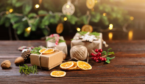 istock Christmas and zero waste, eco friendly packaging gift on wooden background under christmas tree. Eco christmas holiday concept. Sustainable christmas 2187482843