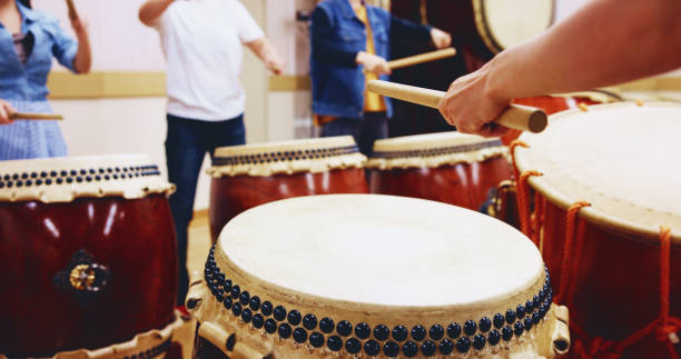 istock Japanese drums, hands and people with sticks on instrument for stage practice, performance or talent. Taiko, class and drummers in band to play in rehearsal for culture, song rhythm or creative beat 2187483233