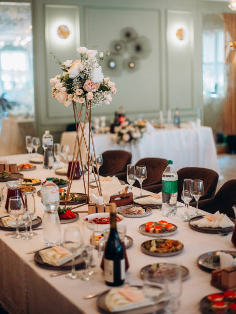 istock A festive and beautifully decorated wedding table. Decorated with flowers.various bottles of drinks, beautiful dishes, salads and sliced meat rolls.vegetable slicing. 2187487312