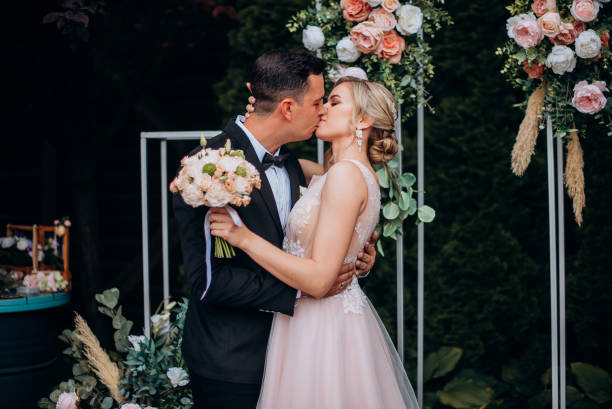 istock Bride and groom kissing on their wedding ceremony 2187487372