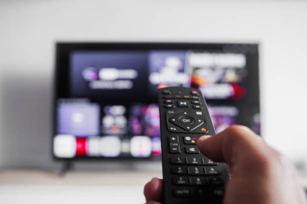 istock A person is holding a remote control in front of a television 2187488711