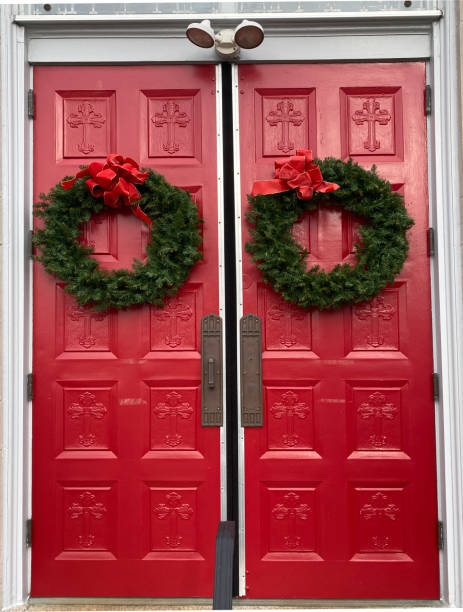 istock Red church doors decorated with wreaths for Christmas 2187489133