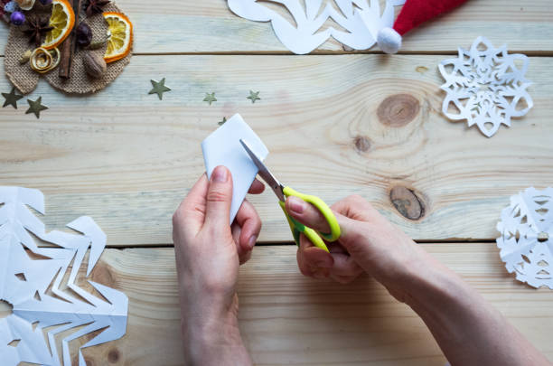 istock A snowflake made from paper with your own hands gracefully decorates a winter interior, adding warmth and a cozy atmosphere 2187491041