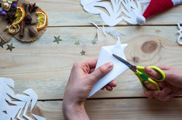 istock A snowflake made from paper with your own hands gracefully decorates a winter interior, adding warmth and a cozy atmosphere 2187491089