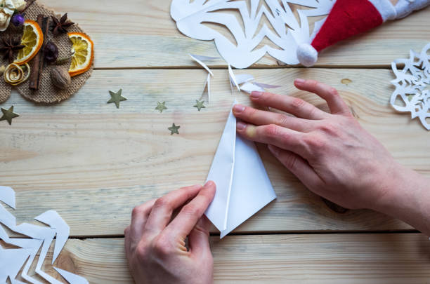istock A snowflake made from paper with your own hands gracefully decorates a winter interior, adding warmth and a cozy atmosphere 2187491181