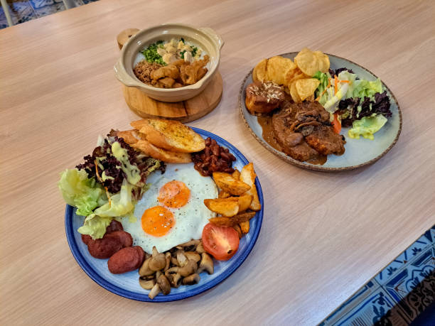 istock Germany Breakfast With Sunny Side Up Eggs, Roast Potato, Roast Tomato, Roast Mushroom, Red Beans, Lettuce, Mix Green Beef Frankfurter And Garlic Bread. Chicken Meat Loaf With Potato, Cheese, BBQ Sauce And Vegetables. Bubur Ayam Kaldu Or Chicken Porridge. 2187494796