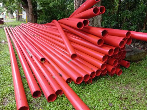 istock Red plastic pipes for water supply on a roadside,under construction 2187497957