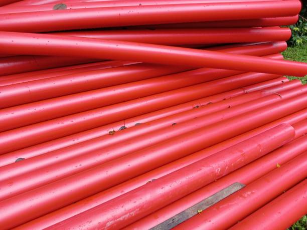 istock Red plastic pipes for water supply on a roadside,under construction 2187497962
