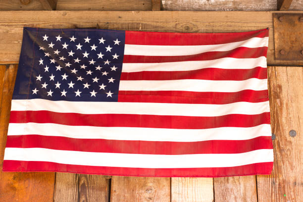 US Flag Tacked Outside Onto Wood Paneling