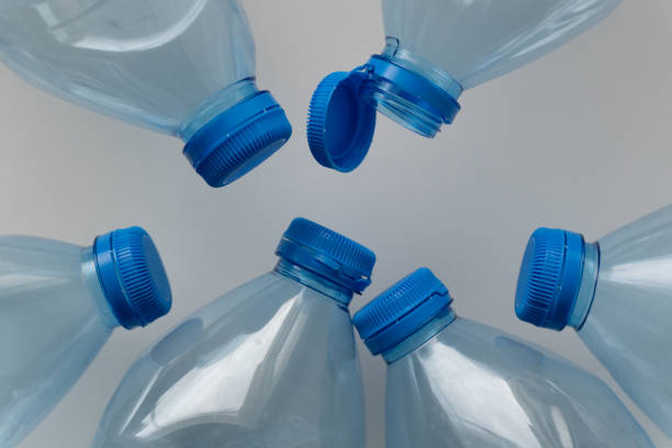 Large stack of old plastic bottles on the floor.