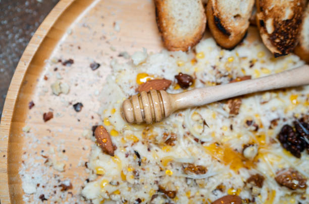 Indulge in the ultimate combination of organic flavors with this beautifully arranged Butter Board. Featuring homemade, creamy butter as the base, topped with a selection of organic, roasted almonds, hazelnuts, walnuts, and tangy cheese, all drizzled with natural honey and paired with vibrant orange crisps. Finely grated nuts are sprinkled on top for added crunch, while a wooden honey spoon adds a touch of rustic elegance. A wholesome, mouthwatering spread that’s perfect for any occasion — all ingredients are organic, made with care for both taste and health.