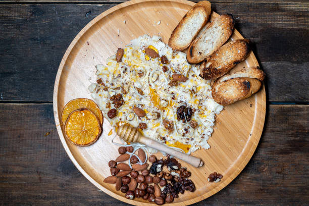 Indulge in the ultimate combination of organic flavors with this beautifully arranged Butter Board. Featuring homemade, creamy butter as the base, topped with a selection of organic, roasted almonds, hazelnuts, walnuts, and tangy cheese, all drizzled with natural honey and paired with vibrant orange crisps. Finely grated nuts are sprinkled on top for added crunch, while a wooden honey spoon adds a touch of rustic elegance. A wholesome, mouthwatering spread that’s perfect for any occasion — all ingredients are organic, made with care for both taste and health.