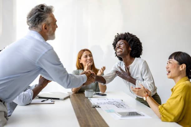 istock Diverse Team Celebrating Success With Cheerful Handshake 2187502386