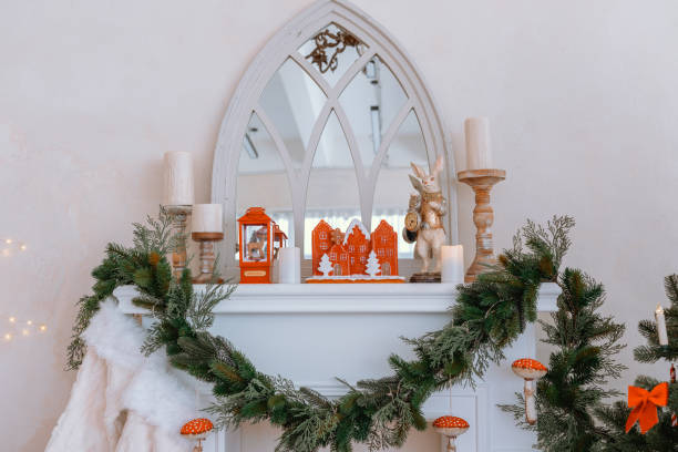 istock Winter mantel decor with greenery, gingerbread house, and candles 2187502457