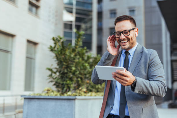 istock Business Professional Using Tablet and Earbuds in City 2187502483
