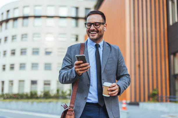 istock Confident Businessman Enjoying Coffee and Messaging on the Go 2187502502