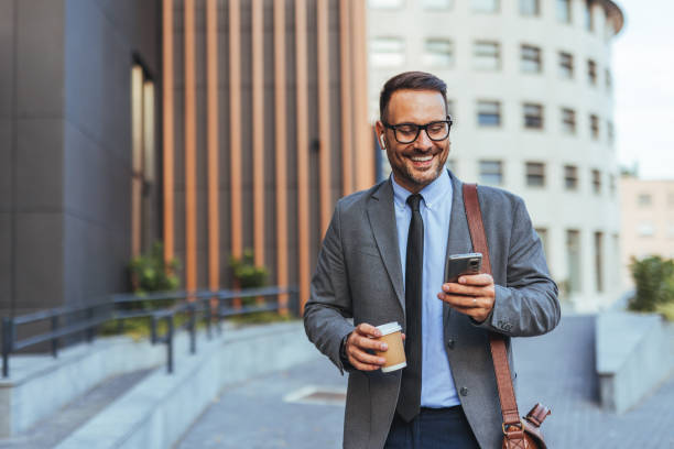 istock Businessman With Coffee Enjoying Outdoor Break While Texting 2187502509