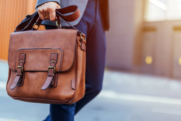 istock Businessman Holding Stylish Leather Briefcase in Urban Setting 2187502518