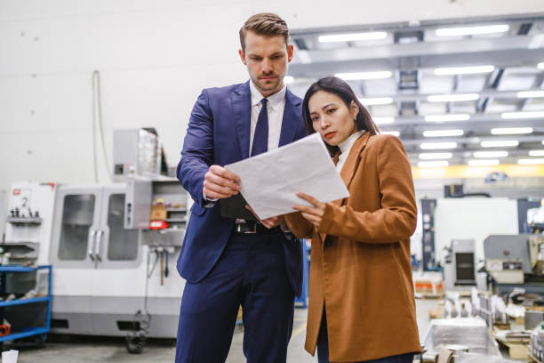istock Warehouse Managers Going Over The Inventory Numbers While Standing In A Big Warehouse 2187503616