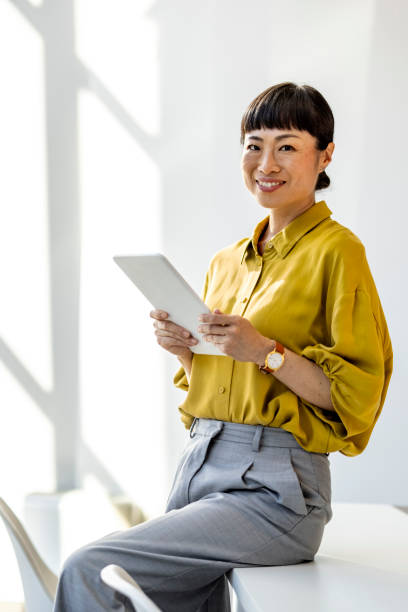 istock Confident Woman Using Tablet in Bright Modern Office 2187503874