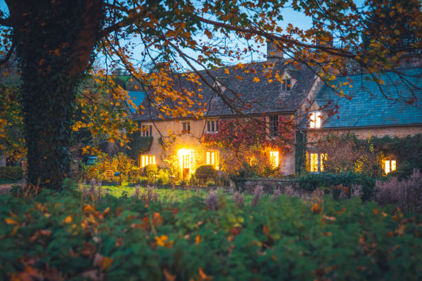 Autumn leaf with blurred wooden house background at night