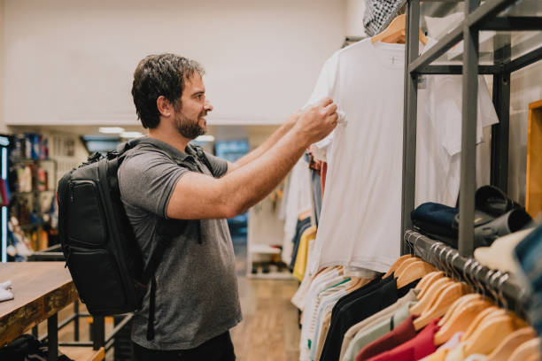 Man choosing t-shirt in store
