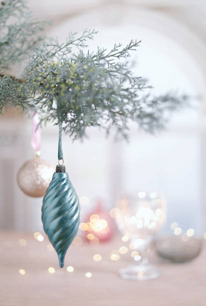 Twisted christmas ornament hanging on branch