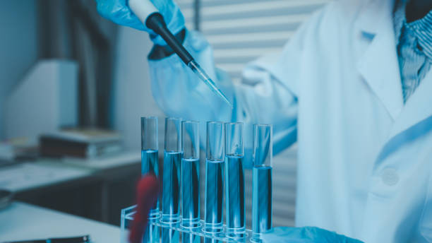 istock a chemist examines a sample of a liquid in a laboratory, a laboratory filled with scientific experiment equipment, microscope, female scientist, female chemist, researcher is searching for scientific 2187515289