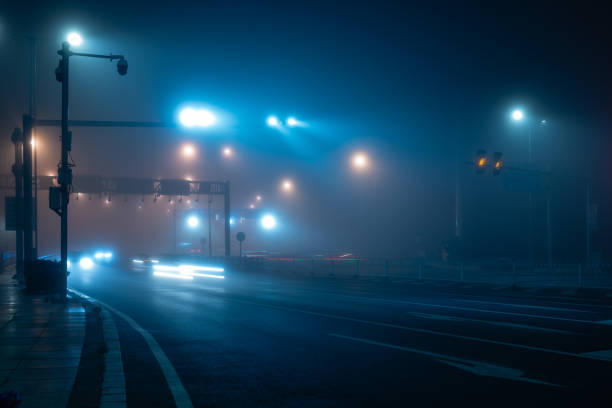 istock Light trail over the bridge highway at a fog night. 2187515369