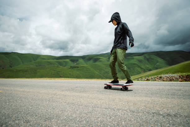istock Skateboarder skateboarding on the mountain road 2187520341
