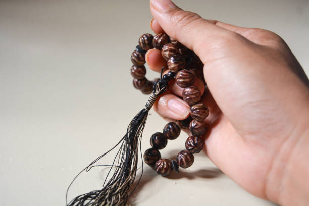 istock Close up view of brown prayer beads on white background. 2187520434