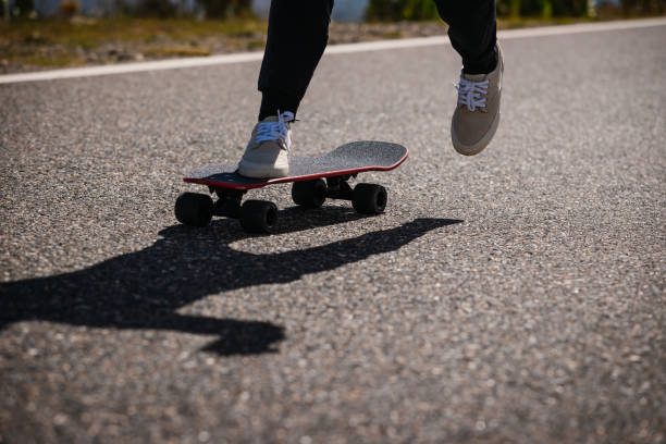 istock Skateboarder skateboarding on the mountain road 2187521548