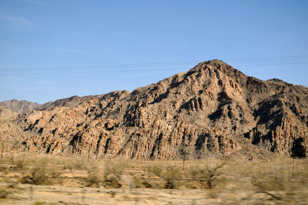 A snapshot of a jagged mountain in the middle of the Arizona desert.