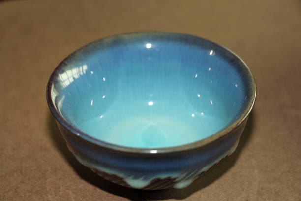 istock Handcrafted ceramic bowl with a vibrant blue glaze displayed on a neutral background 2187530124