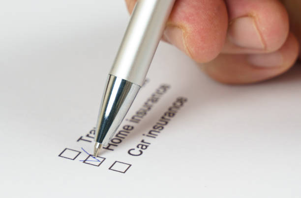 istock Hand holding a pen while checking off home insurance on a list 2187531764