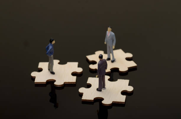 istock Business Conflict: Three Businessmen Pointing at Each Other in a Circle on Black Background 2187534486