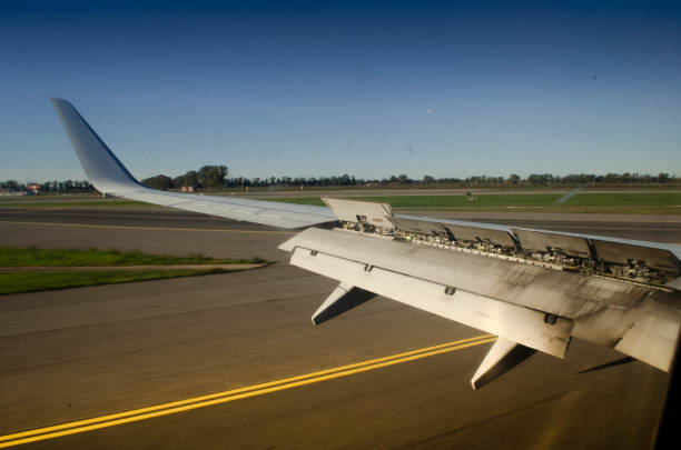 Aircraft Wing with Extended Spoilers A Close Up View on the Runway