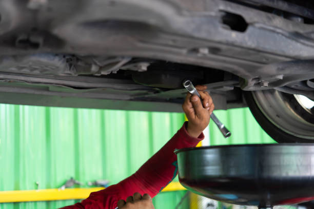 istock Car mechanic drain the old lubricant engine oil 2187539158